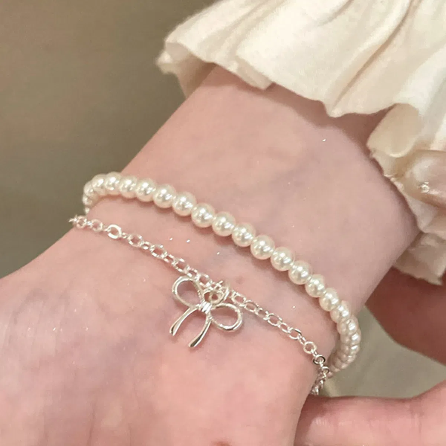 Серебряный браслет с подвеской в виде банта и двойной цепочкой