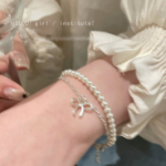 Серебряный браслет с подвеской в виде банта и двойной цепочкой