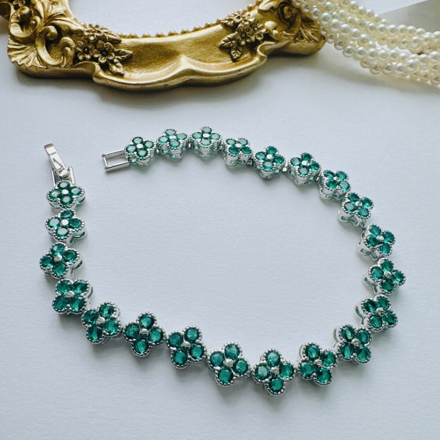 Браслет-теннис с зелёными кубическими цирконами и четырёхлистным клевером из хирургической стали