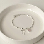 Браслет с сердцем, жемчугом и бантом из латуни