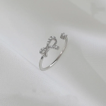 Тонкое серебряное открытое кольцо с подвеской-бантиком и акцентом из кубического циркония